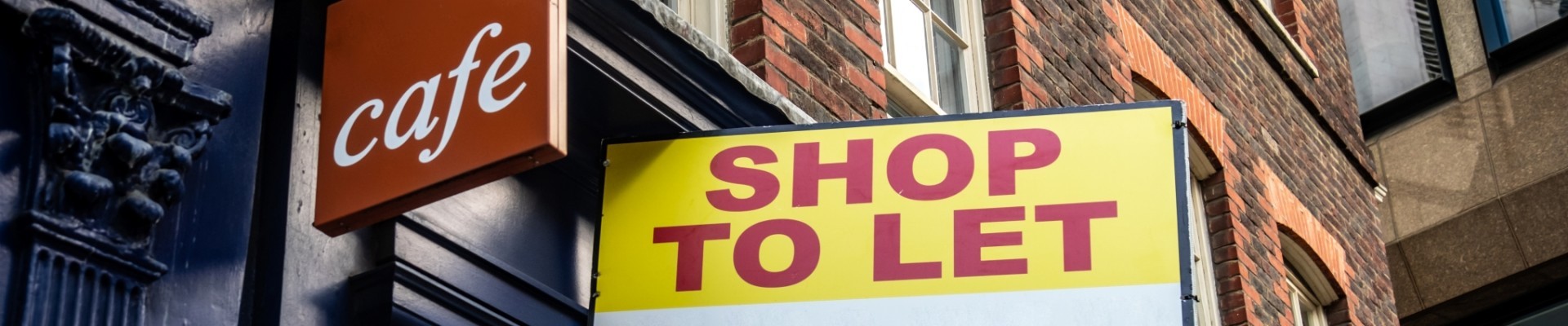 Shop to Let sign on side of vacant food retail business