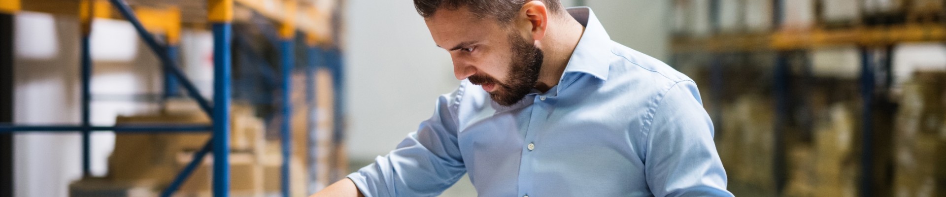 Man warehouse worker with a tablet 
