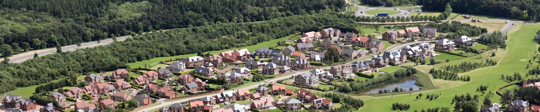 aerial view of a posh housing estate of executive detached houses built on green belt land in England