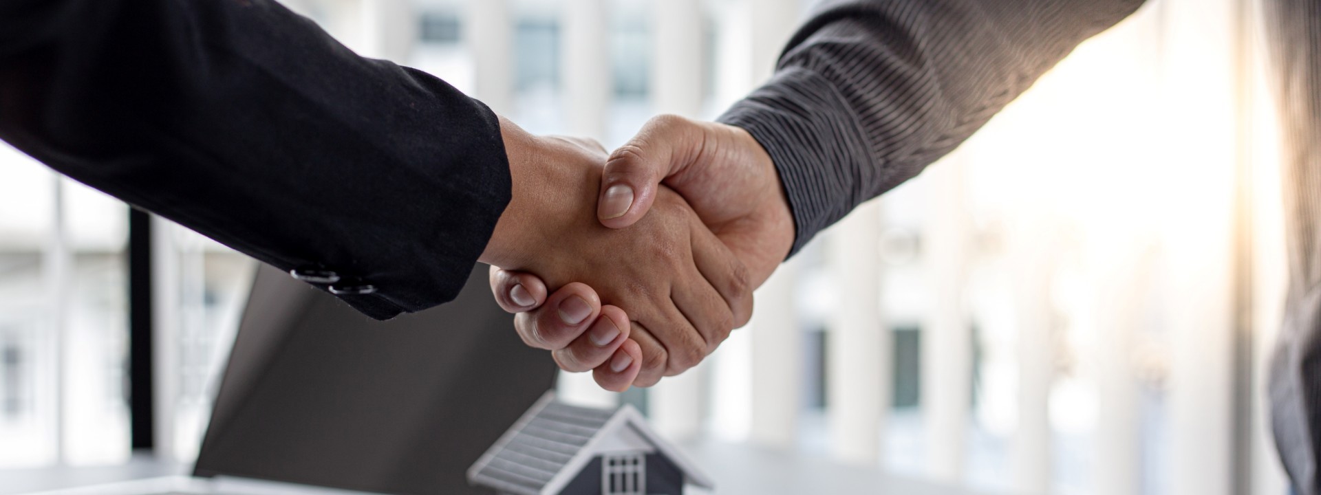 Real estate agents and customers shake hands