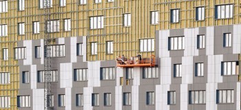 Workers team on construction cradle