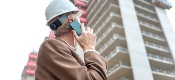 Builing safety and remediation   worker on phone