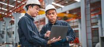 Builing safety and remediation   workers comparing notes