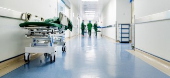 Doctors and nurses walking in hospital hallway, blurred motion