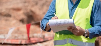 Builing safety and remediation   worker making notes