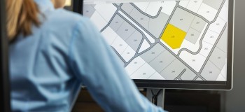 woman working with digital cadastral map land