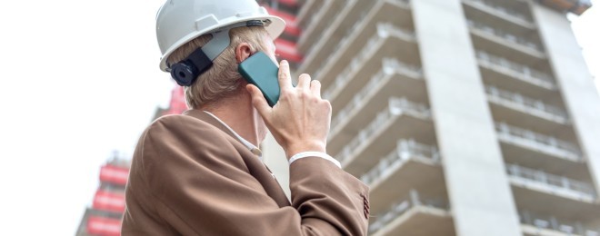 Builing safety and remediation   worker on phone