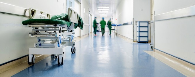 Doctors and nurses walking in hospital hallway, blurred motion