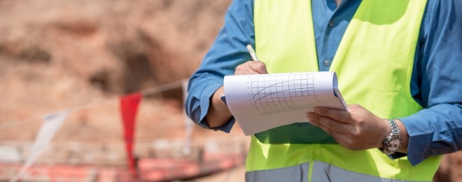 Builing safety and remediation   worker making notes