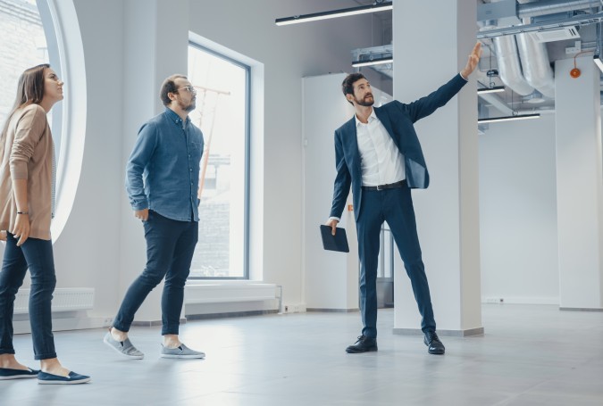 Real Estate Agent Showing a New Empty Office Space 2