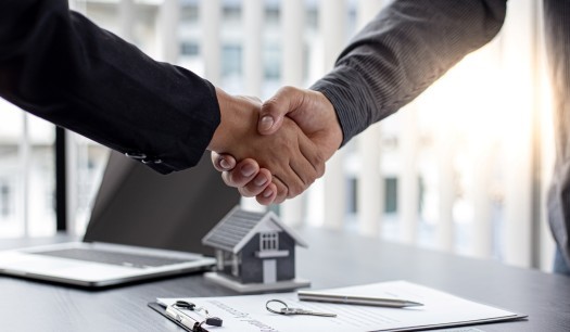Real estate agents and customers shake hands