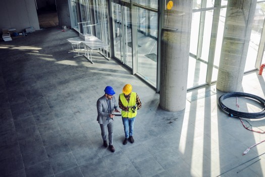 Contractor and architect walking around building