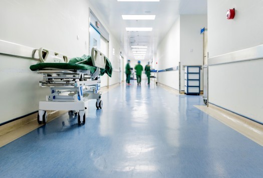 Doctors and nurses walking in hospital hallway, blurred motion