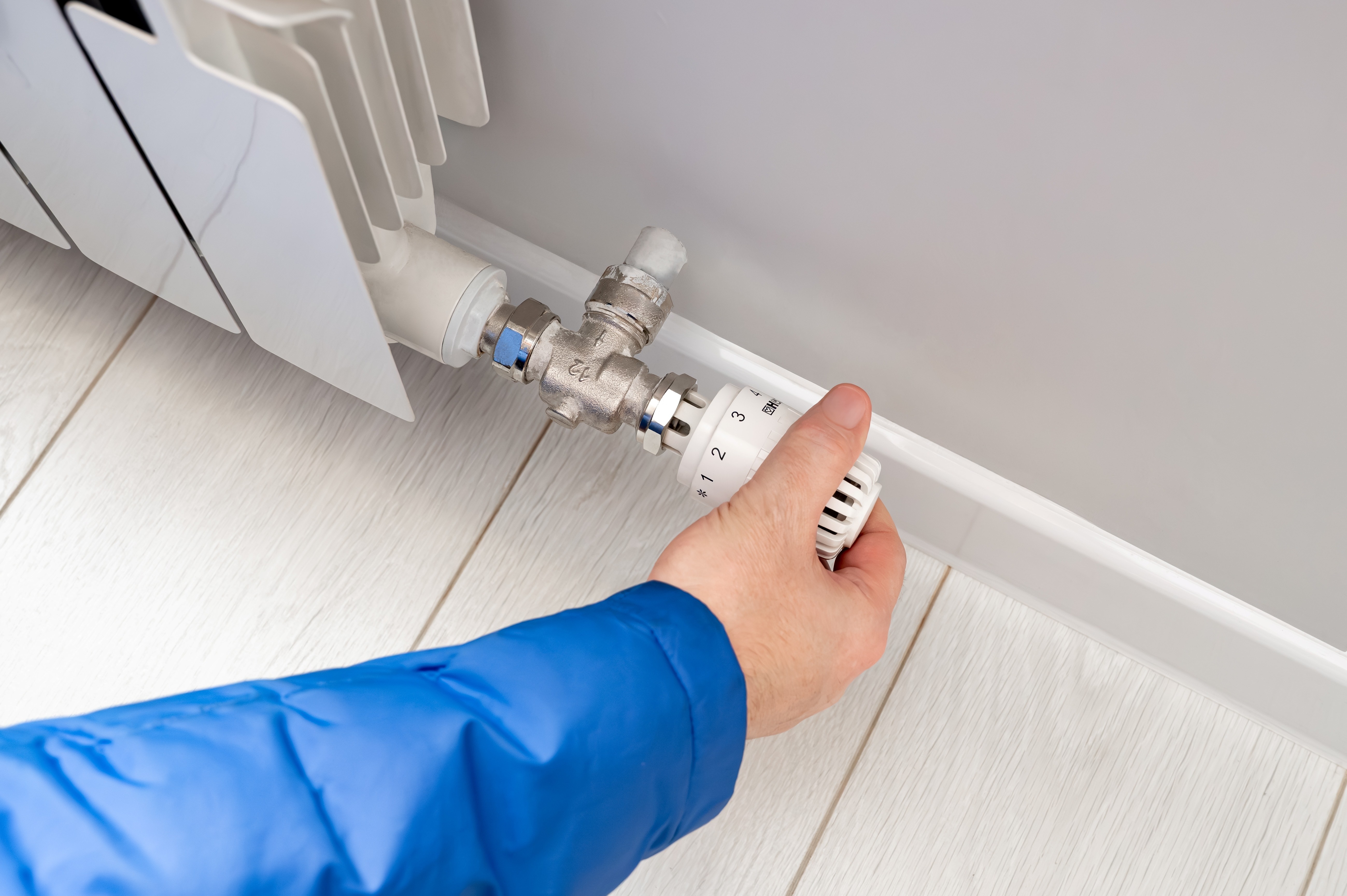 person adjusting radiator