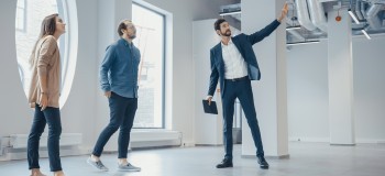 Real Estate Agent Showing a New Empty Office Space 2