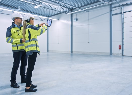 Modern Factory Two Engineers Use Digital Tablet