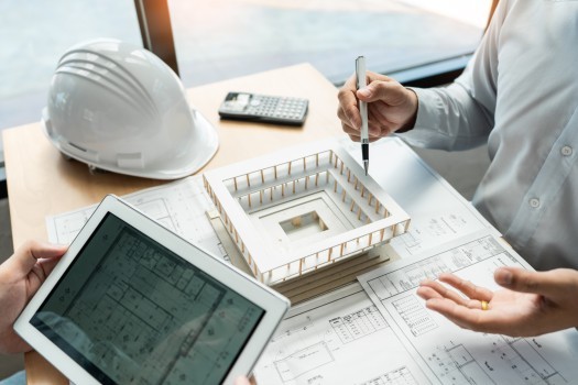 Real estate concept, Two engineer and architect discussing blueprints data working and digital tablet on construction building project